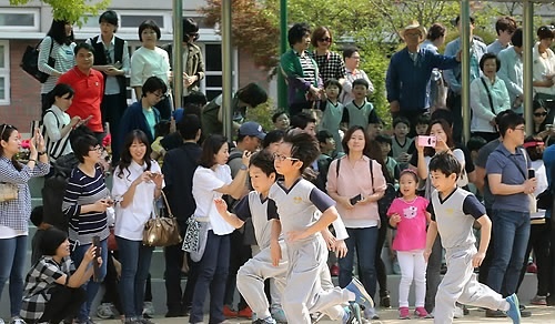↑ 근로자의 날.. 엄마 아빠와 함께!  = 근로자의 날인 1일 오전 서울 중랑구 신내2동 금성초등학교에서 열린 체육대회에서 2학년 학생들의 개인 달리기 시합을 학부모들이 지켜보며 응원하고 있다.