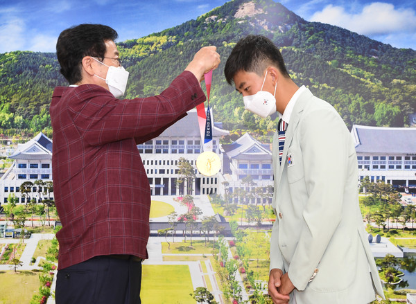 이철우 도지사가 김제덕 선수에게 금메달을 목에 걸어주며 축하했다/Ⓒ경북도