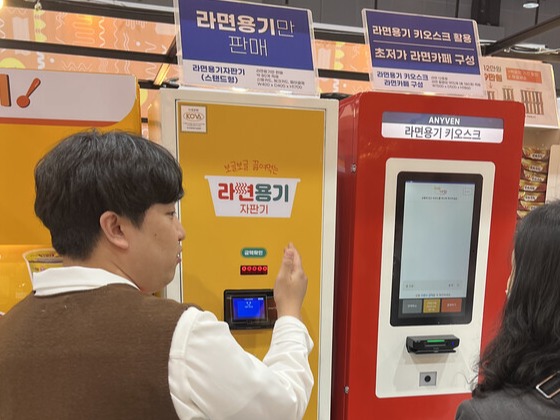 관람객들이 라면박람회 현장에 설치된 '라면용기 키오스크'를 이용해 제품을 구매하고 있다. (사진=서용하)