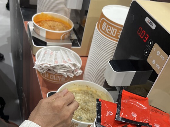 미주웰빙푸드 부스에서는 즉석 시식 코너를 운영해 제품의 깔끔한 맛을 직접 체험할 수 있도록 했다. /관람객들이 시식존에서 라면을 끊이고 있다(사진=서용하)