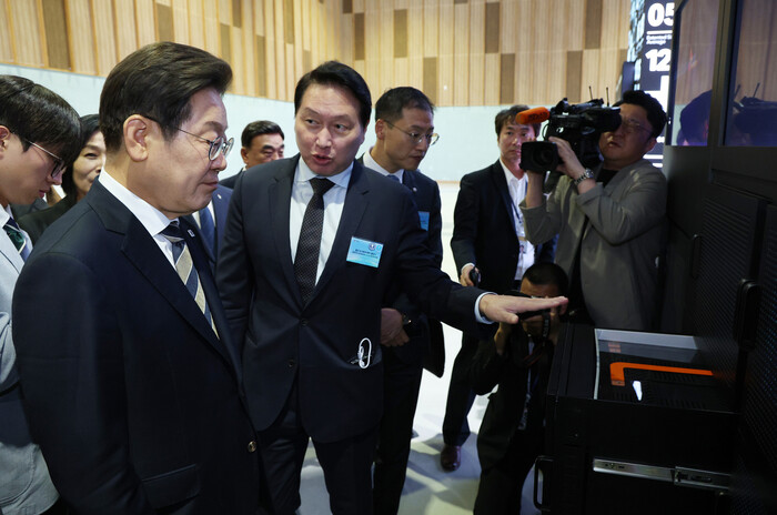 최태원 SK그룹 회장(앞줄 오른쪽)이 20일 울산전시컨벤션센터에서 열린 AI 제품·서비스 시연 행사에서 이재명 대통령에게 설명하고 있다. (사진=연합뉴스)
